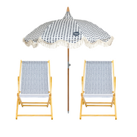 Two deck chairs with polka dot fabric and a matching umbrella, branded 'Splash & Ray'.
