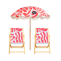 Two wooden deck chairs and a beach umbrella with red and white pattern on a white background, featuring the brand 'Splash & Ray'.