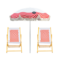 Beach umbrella and two wooden chairs with red and white geometric pattern
